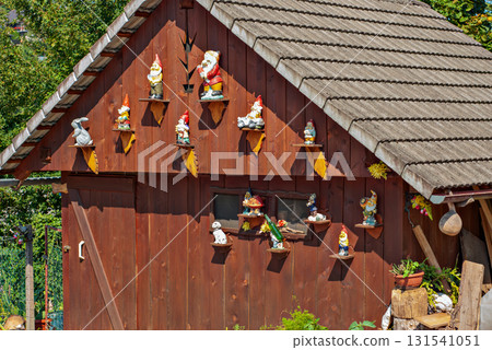 Garden gnomes on wooden shed wall, rustic outdoor collection Garden gnomes on wooden shed wall, rustic outdoor collection 131541051