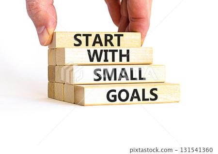 Start with small goals symbol. Concept words phrase Start with small goals on beautiful wooden blocks. Beautiful white background. Businessman's hand Business Start with small goals concept Copy space 131541360