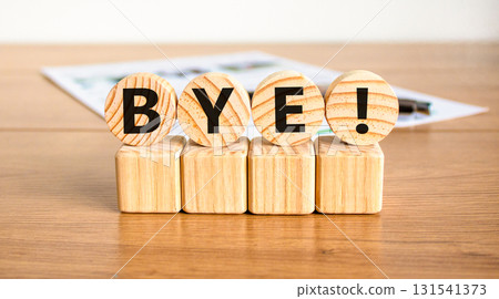 Bye symbol. Concept word Bye on beautiful wooden circles on wooden blocks. Beautiful wooden table white background. Business and bye concept. Copy space. Bye symbol. Concept word Bye on beautiful wooden circles on wooden blocks. Beautiful wooden table white background. Business and bye concept. Copy space. 131541373