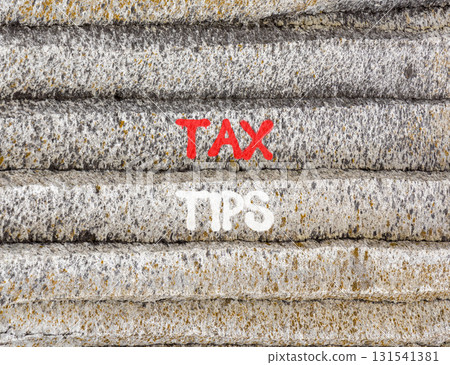 Tax tips symbol. Concept word Tax tips on beautiful grey mountain wall. Beautiful grey mountain wall background. Business tax tips concept. Copy space. Tax tips symbol. Concept word Tax tips on beautiful grey mountain wall. Beautiful grey mountain wall background. Business tax tips concept. Copy space. 131541381