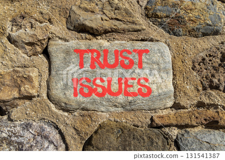 Trust issues symbol. Concept word Trust issues on beautiful grey stone on stone wall. Beautiful stone wall background. Business trust issues concept. Copy space. Trust issues symbol. Concept word Trust issues on beautiful grey stone on stone wall. Beautiful stone wall background. Business trust issues concept. Copy space. 131541387
