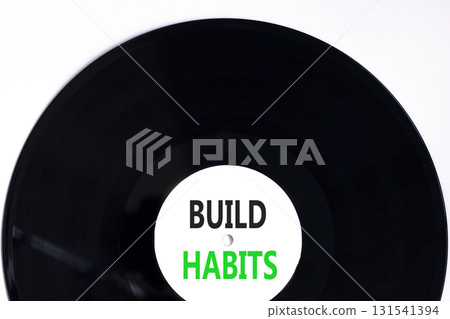 Build habits symbol. Concept word Build habits on beautiful black and white vinyl disk. Beautiful white paper background. Business build habits concept. Copy space. 131541394