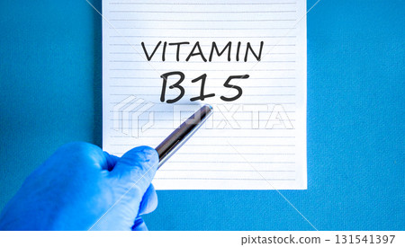Vitamin B15 pantothenic acid symbol. Concept words Vitamin B15 on beautiful white note. Doctor's hand in blue medical glove. Beautiful blue background. Medical healthy lifestyle Vitamin B15 concept. 131541397