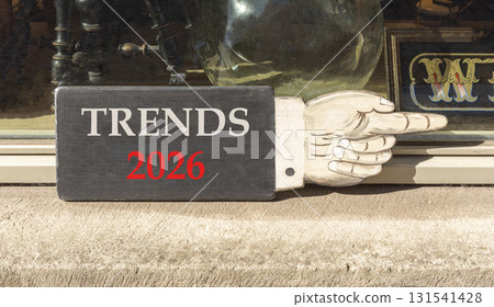 Trends 2026 new year symbol. Concept words Trends 2026 on beautiful black wooden hand sign. Beautiful shop display background. Business and Trends 2026 new year concept. Copy space. 131541428