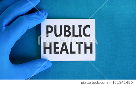 Public health symbol. Concept words Public health on beautiful white card. Doctor's hand in blue medical glove. Beautiful blue background. Medical healthy lifestyle public health concept. 131541490