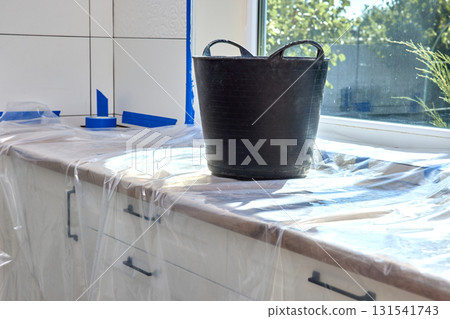 wall repair tools. plaster bucket on kitchen countertop. renovation work, copy space 131541743