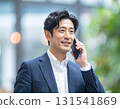 A middle-aged man talking on the phone, a business scene in a bright office district 131541869