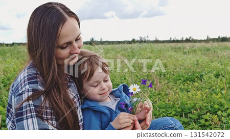 Happy family. mom and son in nature. Mom, child play together in park. Family walk in outdoors. Parents, daughter having carefree fun in nature, they enjoy nature. 131542072