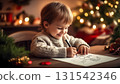Caucasian smiling 5 years old boy draws a Christmas picture in his room sitting among Christmas decoration. 131542346