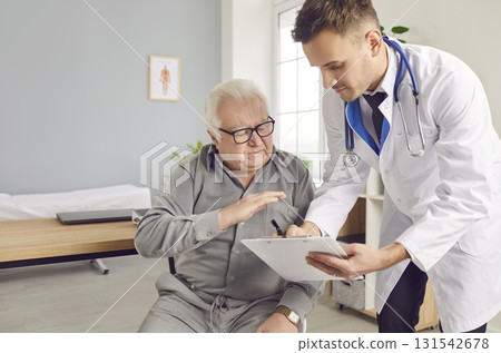 Doctor showing medical test results to senior elderly man patient and prescribe treatment in clinic 131542678