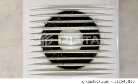 Close-up of an electric range hood clogged with dust and cobwebs, dirty exhaust fan in the bathroom with accumulated dirt, concept of pollution, poor ventilation and need of cleaning 131543880