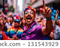 Man in rainbow headdress and purple shirt on Pride parade. Concept of LGBTQ community equality movement, lgbt happy pride month Man in rainbow headdress and purple shirt on Pride parade. Concept of LGBTQ community equality movement, lgbt happy pride month 131543929