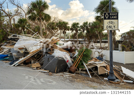 Piles of debris on street side in Florida. Hurricane aftermath cleanup. Garbage from severely damaged homes after storm surge. Consequences of natural disaster 131544155