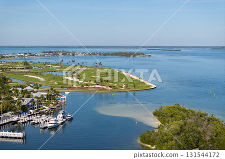Oceanfront golf course in sunny Florida. Outdoor sport grounds with green grass lawns in Boca Grande, small town on Gasparilla Island 131544172