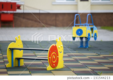Kindergarten playground with bright toy car and funny bench. Children activities and recreation outdoors. Kindergarten playground with bright toy car and funny bench. Children activities and recreation outdoors. 131544213