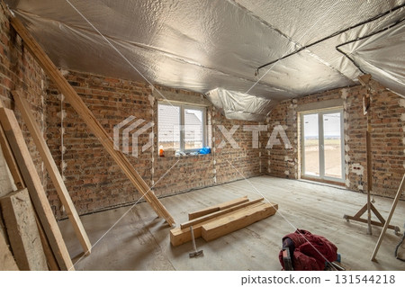 Interior of unfinished brick house with concrete floor and bare walls ready for plastering under construction. Real estate development 131544218