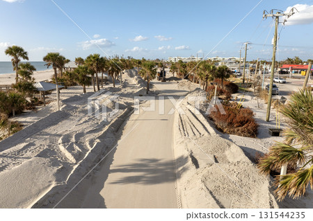 Hurricane Milton aftermath cleanup. Piles of debris and sand on street side on Manasota Key in Florida Hurricane Milton aftermath cleanup. Piles of debris and sand on street side on Manasota Key in Florida 131544235