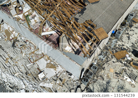 Hurricane Ian destroyed house roof and walls in Florida residential area. Natural disaster and its consequences Hurricane Ian destroyed house roof and walls in Florida residential area. Natural disaster and its consequences 131544239