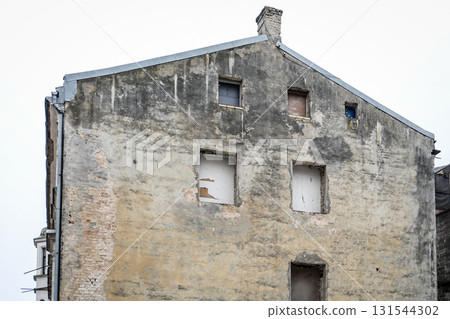 Old Building Wall with Exposed Brick and Empty Windows 131544302