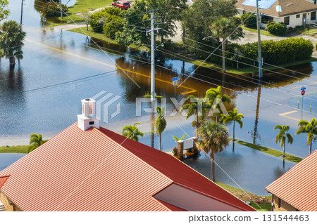 Flooding in Florida caused by tropical storm from hurricane rainfall. Suburb houses in residential community surrounded by flood waters. Aftermath of natural disaster 131544463