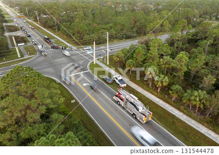First responders responding to car accident site on American street. Emergency services helping victims of vehicle crash on road in USA 131544478