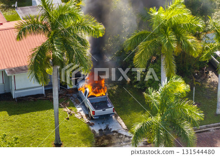 First responders extinguishing fire on burning vehicle. Emergency service personnel responding to car accident on Florida street 131544480