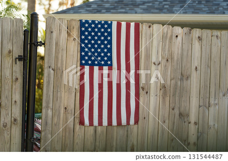Fence in Florida backyard. Wooden fencing from board planks for grounds protection and privacy Fence in Florida backyard. Wooden fencing from board planks for grounds protection and privacy 131544487