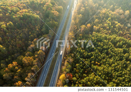 Elevated view of freeway road lanes between autumn mountain hills. Interstate transportation infrastructure in USA 131544501
