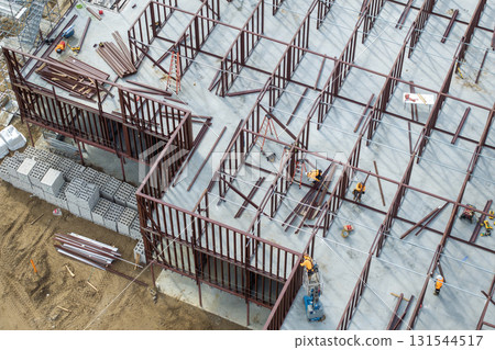 Development of commercial housing in USA. Construction works on monolithic frame. Large building site with scattered workers and equipment. Real estate market Development of commercial housing in USA. Construction works on monolithic frame. Large building site with scattered workers and equipment. Real estate market 131544517