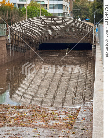 Flooded tunnel in city area reflecting metal canopy and dirty stormwater. Concept of Environmental Damage, Urban Flood Risk, Rain and Storm, City Infrastructure, Climate Crisis Flooded tunnel in city area reflecting metal canopy and dirty stormwater. Concept of Environmental Damage, Urban Flood Risk, Rain and Storm, City Infrastructure, Climate Crisis 131544751