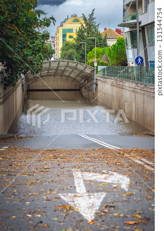 City underpass completely submerged after torrential rainfall, road markings. Concept of Weather and Climate, Flood, Storm Aftermath, Urban Environment, Transportation Disruption, Emergency Situations City underpass completely submerged after torrential rainfall, road markings. Concept of Weather and Climate, Flood, Storm Aftermath, Urban Environment, Transportation Disruption, Emergency Situations 131544754