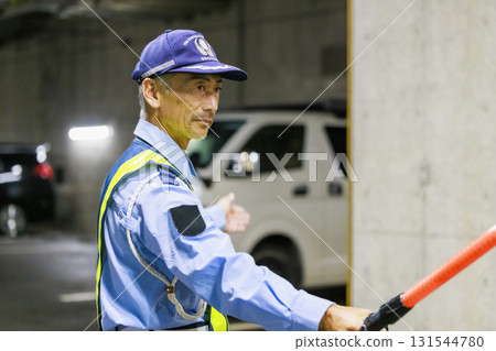 A security guard directing traffic 131544780