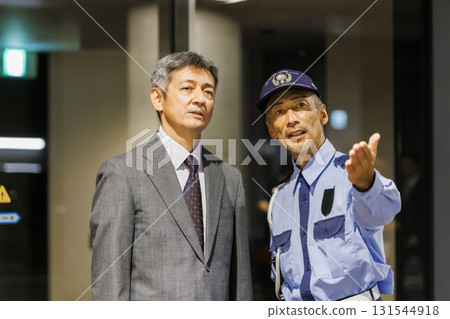 Security guard giving a tour of the facility Security guard giving a tour of the facility 131544918