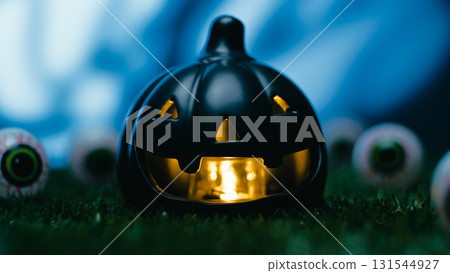 Horror Halloween black pumpkin amidst scary eyes at night Horror Halloween black pumpkin amidst scary eyes at night 131544927