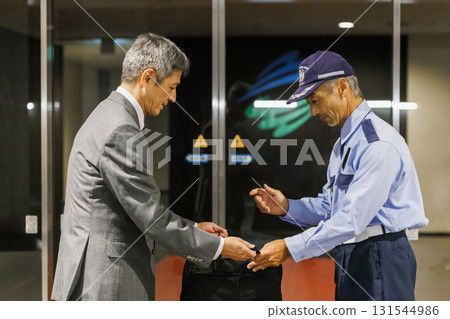 Security guard inspecting baggage Security guard inspecting baggage 131544986
