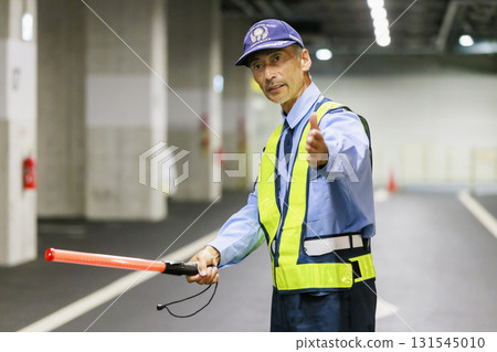 A security guard directing traffic A security guard directing traffic 131545010