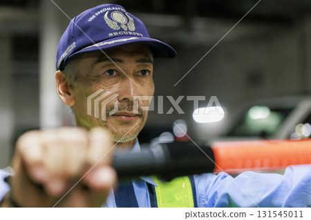 A security guard directing traffic A security guard directing traffic 131545011
