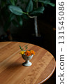 Marigolds in a small antique ceramic vessel 131545086