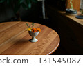 Marigolds in a small antique ceramic vessel 131545087