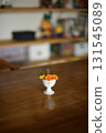 Marigolds in a small antique ceramic vessel 131545089