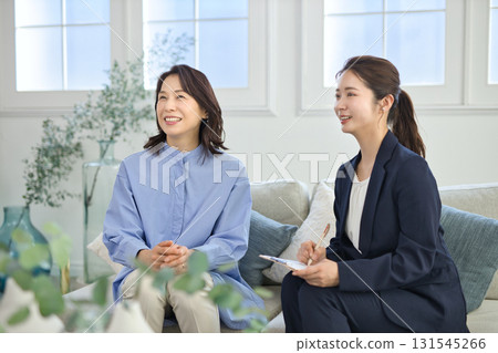 A young businesswoman explaining to a middle-aged woman A young businesswoman explaining to a middle-aged woman 131545266
