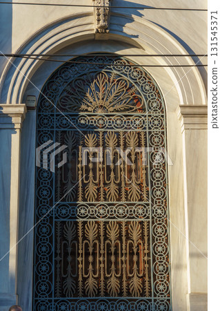 Ornate Wrought Iron Gate in Istanbul - Intricate Floral and Geometric Patterns on Arched Door at Golden Hour 131545371