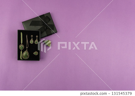 Chrysolite Jewelry Set in Gift Box on Pink Background with Copy Space Chrysolite Jewelry Set in Gift Box on Pink Background with Copy Space 131545379