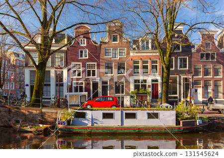 Canal house and boat in Amsterdam Netherlands 131545624
