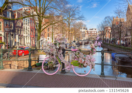 Decorated bicycle by canal in Amsterdam Netherlands 131545626