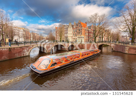 Canal cruise boat on the Herengracht in Amsterdam Netherlands 131545628