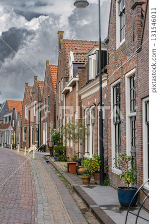 Charming view of Monnickendam, a traditional Dutch village with canals, historic houses, and serene atmosphere. 131546011
