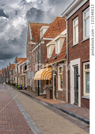 Charming view of Monnickendam, a traditional Dutch village with canals, historic houses, and serene atmosphere. Charming view of Monnickendam, a traditional Dutch village with canals, historic houses, and serene atmosphere. 131546013