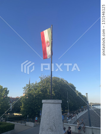 Flag of Hungary Flying High Near a Monument by the River Flag of Hungary Flying High Near a Monument by the River 131546125