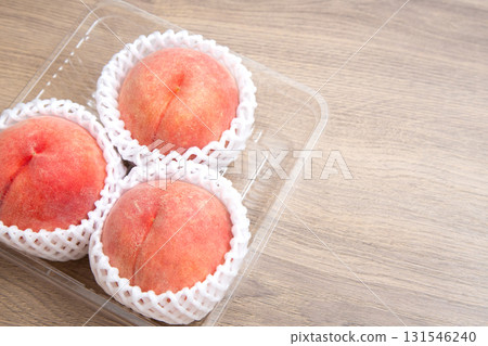 Peaches wrapped in cushioning material Copy space Peaches wrapped in cushioning material Copy space 131546240
